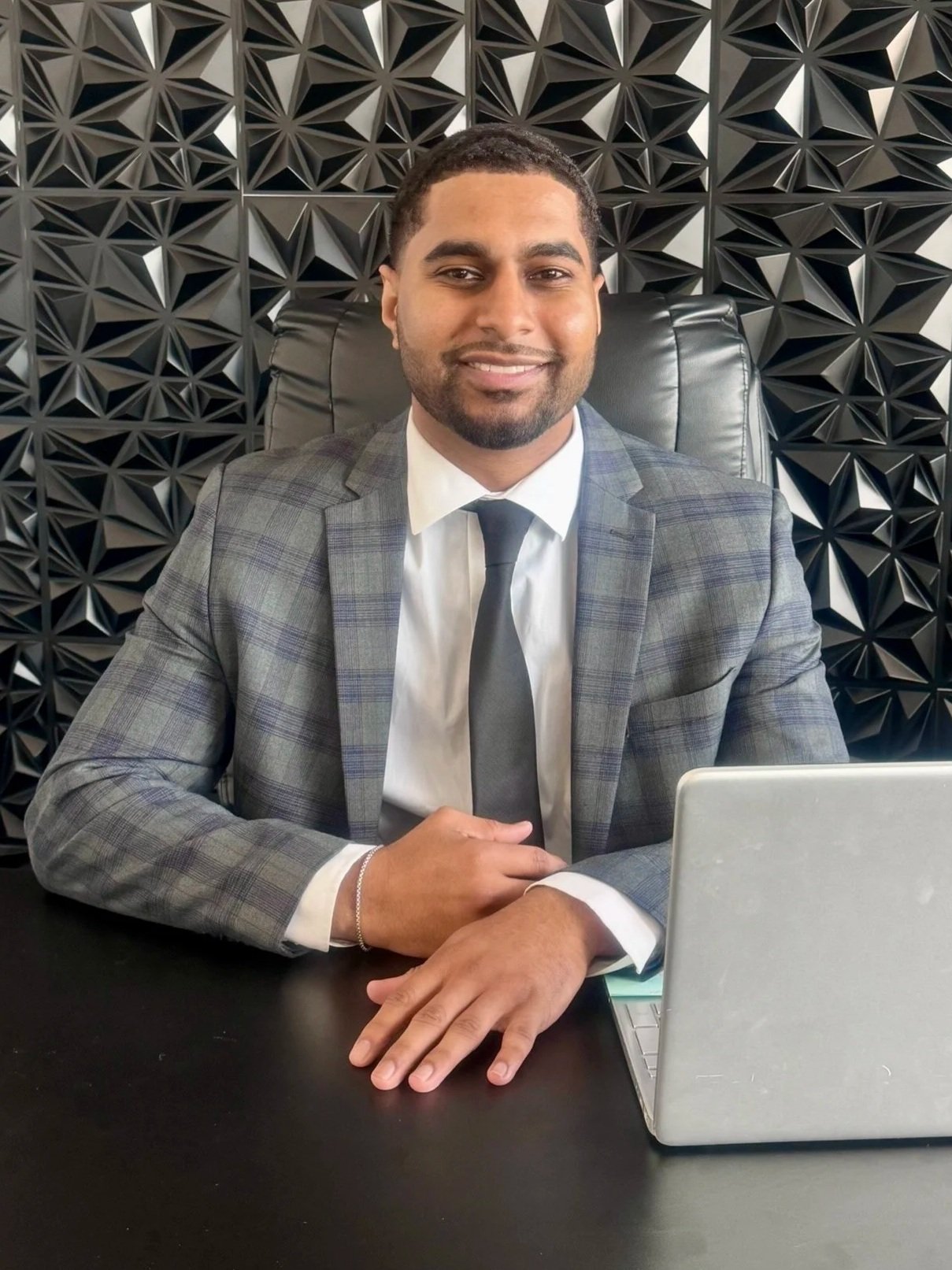 Dakota, founder of Victory Point Consulting, working at his desk